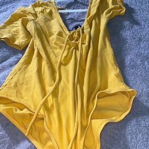 yellow body suit